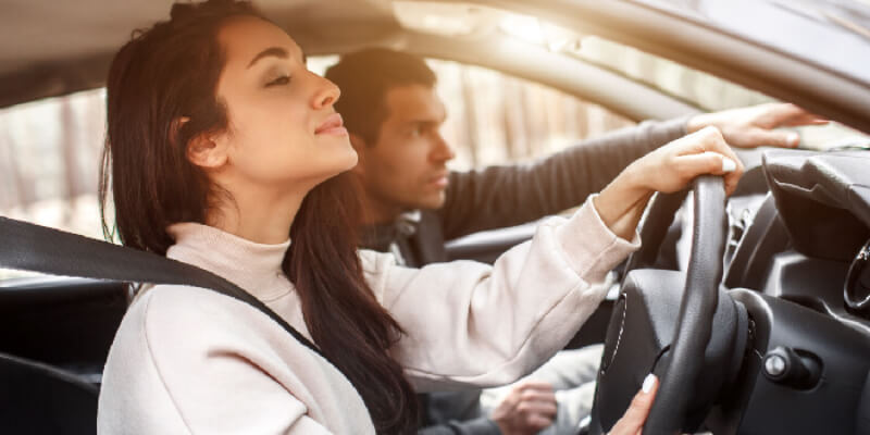 Learner with instructor in car pointing over the dashboard