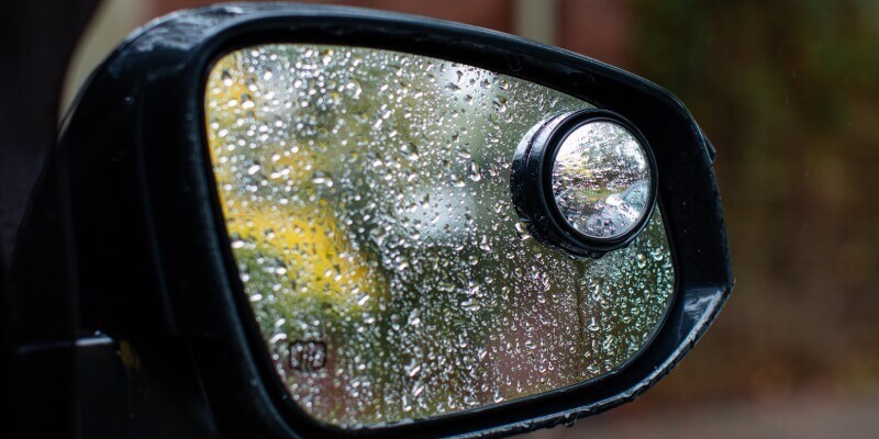 Drivers wing mirror with blind spot mirror and raindrops